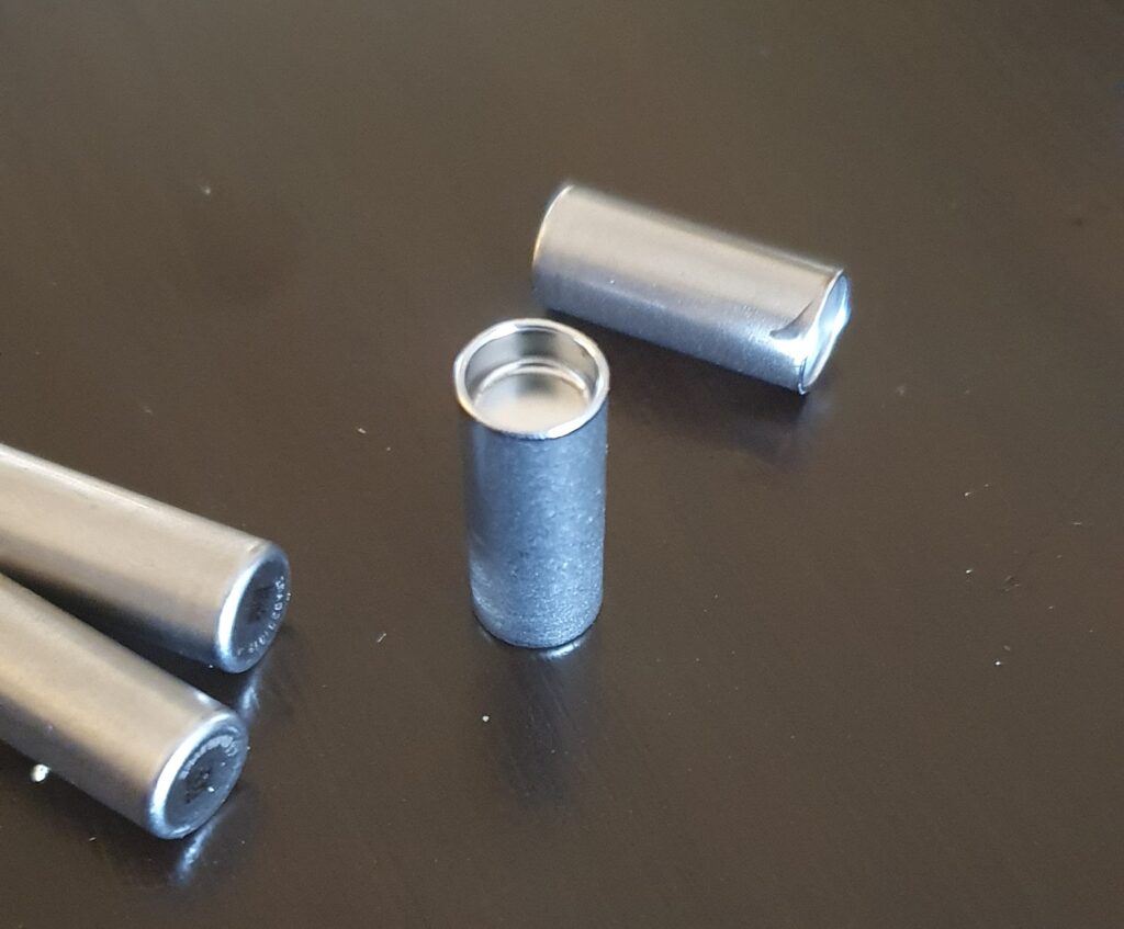 four tiny stainless steel capsules