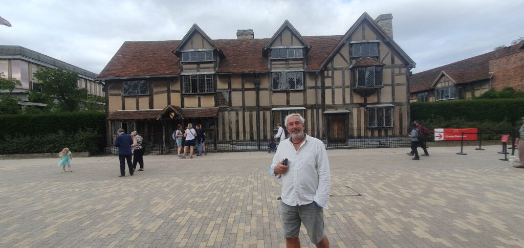oliver standing in front of shakespeare's house